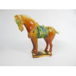 A Chinese Tang style polychrome glazed pottery figure of a horse