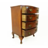 A small bow fronted mahogany chest of four long drawers