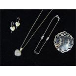 A silver necklace, a silver bracelet, a silver brooch and a pair of earrings