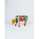 A colourful hand-painted cow possibly American; 29 cm long