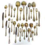 A large collection of 'German silver' cutlery with cast, floral and cartouche handles