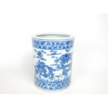 A Chinese, porcelain, blue and white, brush pot adorned with ferocious dragons