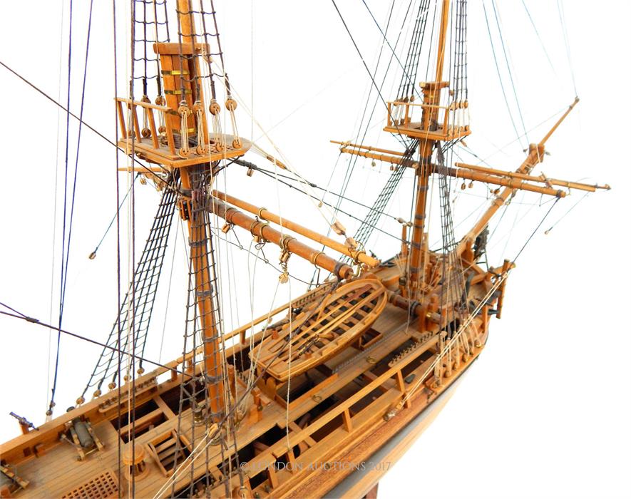 A wooden plank built model of the HMS Bounty with stand; approximately 93cm long overall. - Image 4 of 4