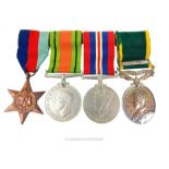 A group of four medals including a George V Territorial Efficiency Medal