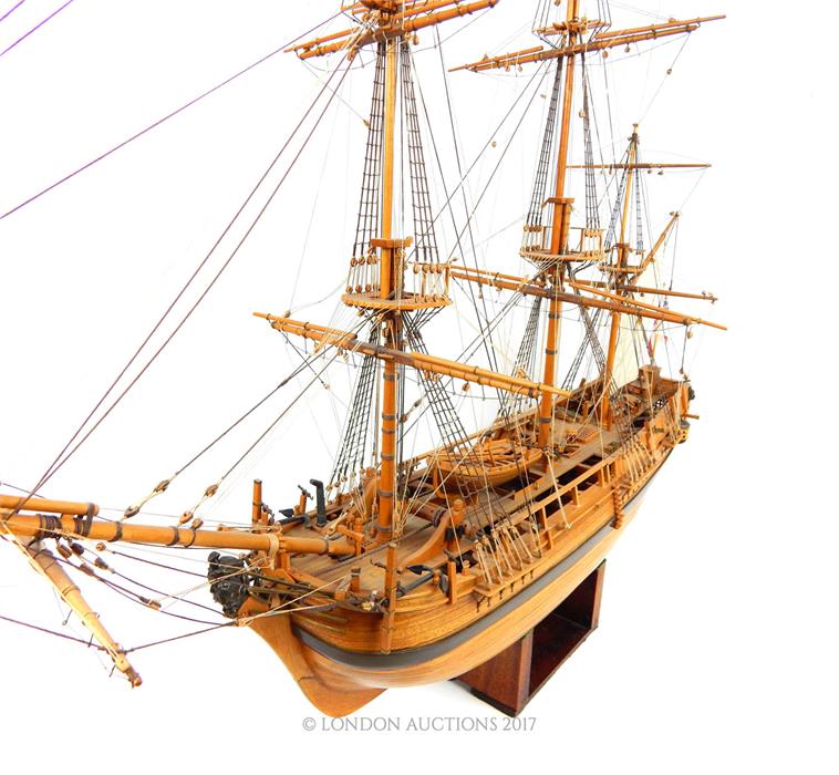 A wooden plank built model of the HMS Bounty with stand; approximately 93cm long overall. - Image 2 of 4