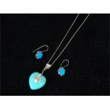 A silver and turquoise necklace and earrings