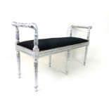 A silvered stool, upholstered in black material.