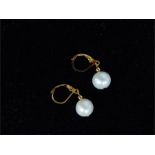 An elegant, boxed, pair of 14 ct yellow gold and South Sea white pearl drop earrings