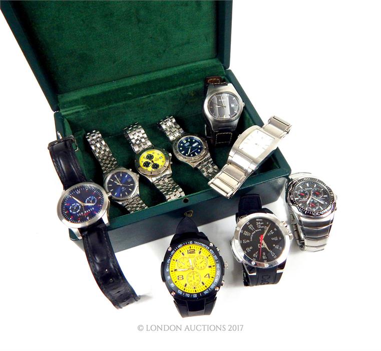 A green leather box containing nine assorted gentleman's, stainless steel wristwatches