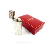 A Cartier silver plated lighter, in original red Cartier box