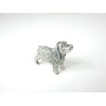 A cast sterling silver figure of a dog