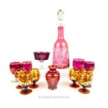 A collection of 13 ruby and amber glass wares including a decanter.