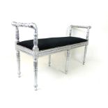 A silvered stool upholstered with black fabric.