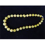 A string of graduated green hardstone beads