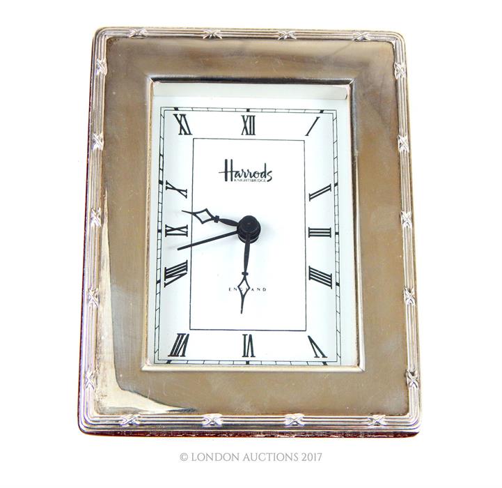 A Harrods hallmarked sterling silver framed desk clock