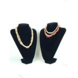 A coral necklace, with a faux freshwater pearl necklace, and a shell graduated beaded necklace