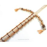 A mounted, early 20th century, woven sword inset with shark's teeth