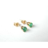 A pair of emerald stud earrings.