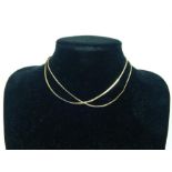 A 14ct gold gold flat chain, together with a 9ct gold fine chain