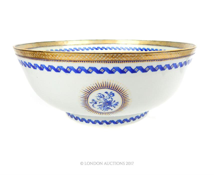 A large Eastern blue and white bowl with gilt decorated rim; 33cm diameter.