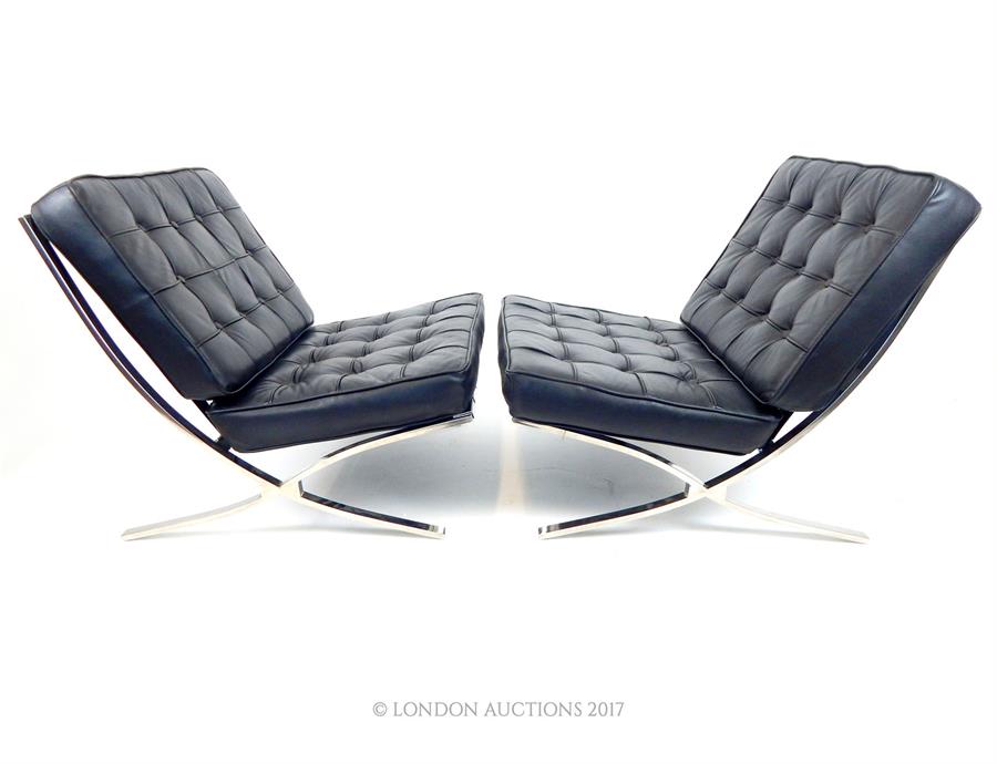 A pair of stylish, Barcelona- style chairs on chromed supports