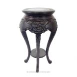 A Chinese hardwood jardiniere stand with circular top; 76cm high