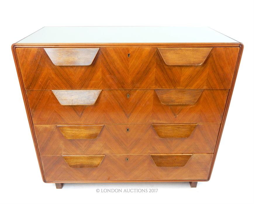 A mid 20th century Continental walnut chest of four long drawers