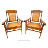 A pair of Dutch Indonesian teak chairs with rattan seats.