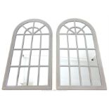 A pair of matt finish grey painted framed garden mirrors; 129 cm