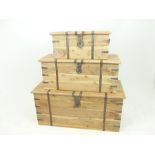 A graduated set of three iron bound natural finished, teak chests; 47 x 101 x 45cm