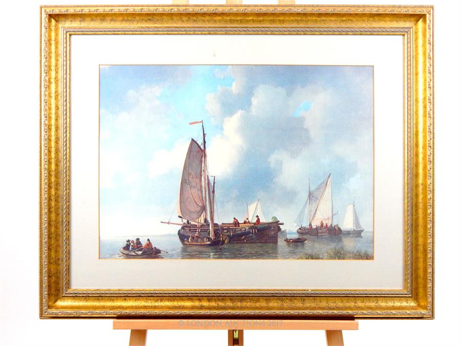 A print of ships mounted within a gold frame