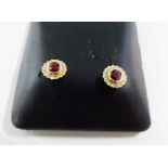 A pair of 18ct ruby and diamond stud earrings.