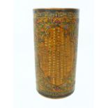 A large Chinese lacquer pot with three panels of text framed by floral decorations; with a six