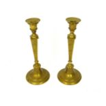 A pair of engraved brass candlesticks; 33cm high.