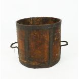 An antique cylindrical wood log bin, with iron banding and handles