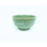 A Chinese celadon style ware bowl decorated with a dragon; 16.5cm diameter.