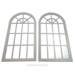 A pair of rounded arch wall mirrors