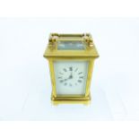 A brass carriage clock with Roman numeral dial, engraved "EW Sinclair"; a/f.