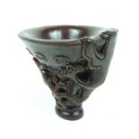 A Chinese horn libation cup with four character mark to its base; 11cm high.