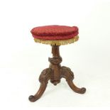 A Victorian carved mahogany stool with a tripod base featuring back scroll legs; seat a/f.