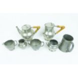 A collection of planished pewter to include a 'Tudric' set and 'Warric' items