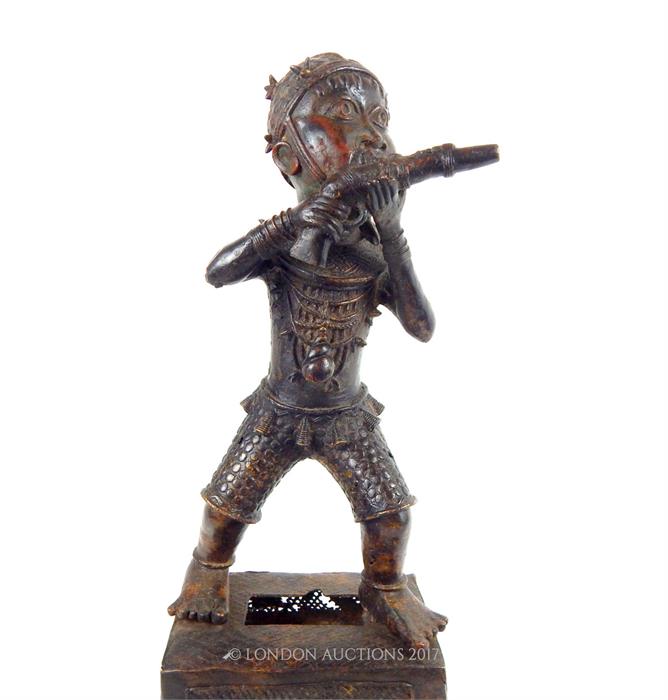 A Benin bronze figure of a man firing a gun