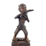 A Benin bronze figure of a man firing a gun