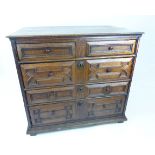 An 18th century geometric oak chest of drawers with two short over three long drawers; 95cm wide;