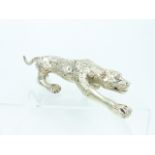 A Chinese white metal figurine of a leopard; 37cm long.