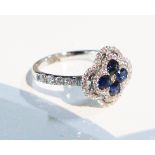An 18ct white gold sapphire and diamond four leaf clover style ring.