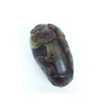 A carved agate stone with the figure of a holy man; 9cm long.