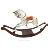 A CARVED WOODEN ROCKING HORSE; Victorian design , dapple grey with real hair , leather tack , on