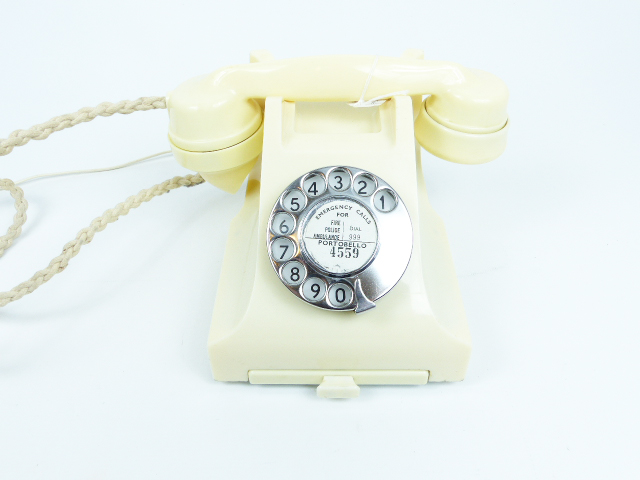 A 1955 style GPO telephone with slide drawer in ivory white; with modern wiring.
