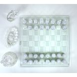 A complete, boxed, clear and frosted glass chess set and board with other items